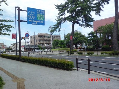 市役所の交差点、写真中央ビルの1階にかわらやと宮ざき店があります。右の建物は市役所です。